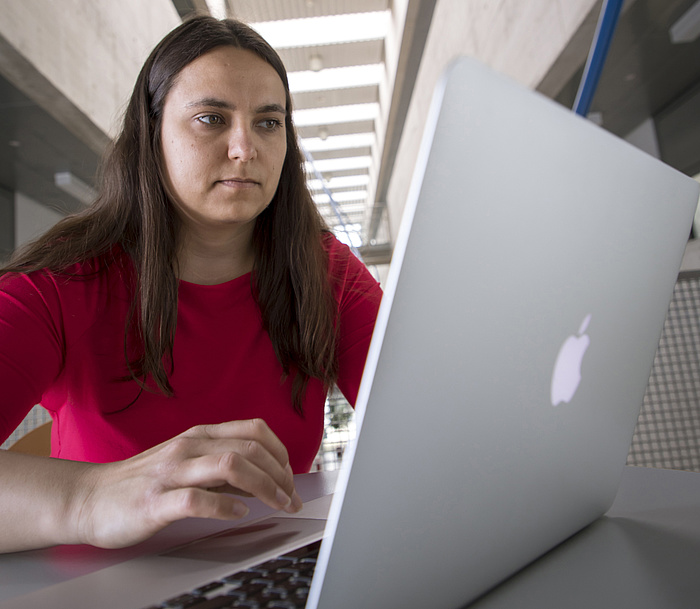 A woman works on a laptop