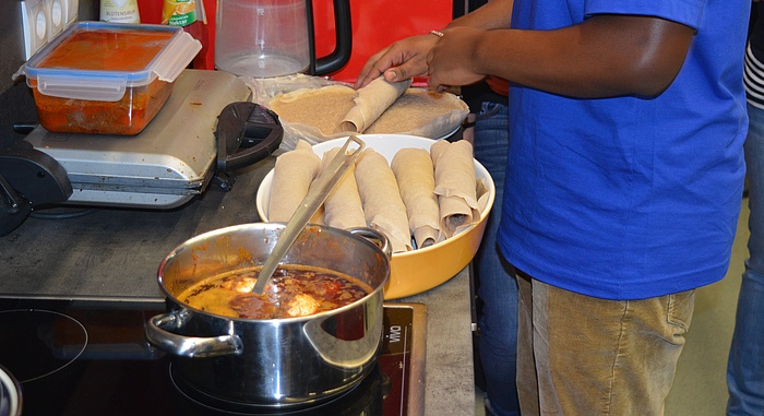 The Ethiopian dish Minchet Abish simmers on the cooker while the cook rolls up the flat bread which traditionally accompanies the meal.