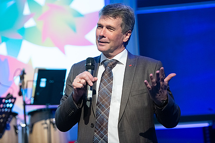 A man speaks into a microphone.