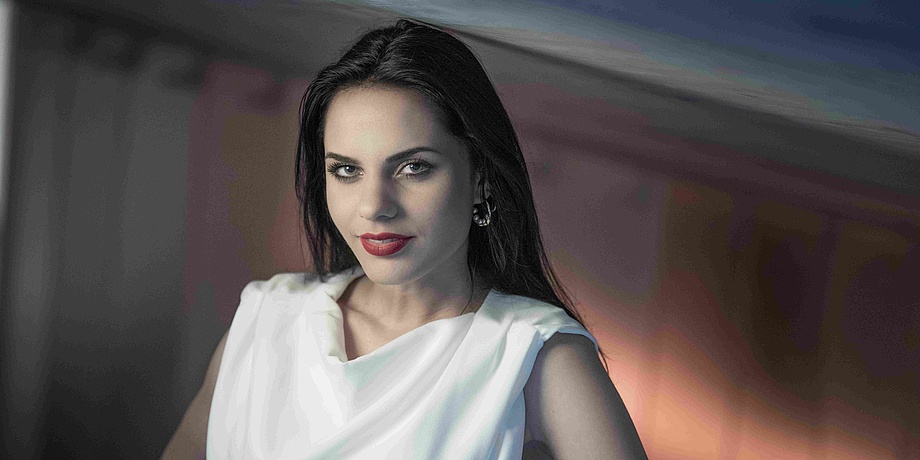 Portrait photo of a young, dark haired woman.