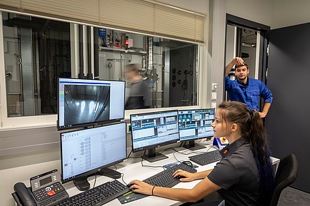 Technician and technician at a control panel