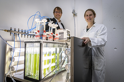 Man and Woman behind Laboratory equipment