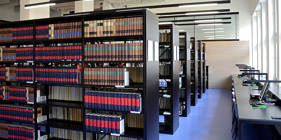 Several rows of bookshelves and desks.