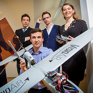 Several people with a model airplane. Photo source: Lunghammer - TU Graz