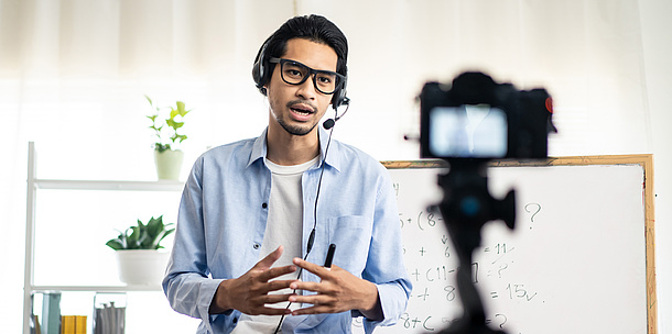 A man speaks in front of a camera.