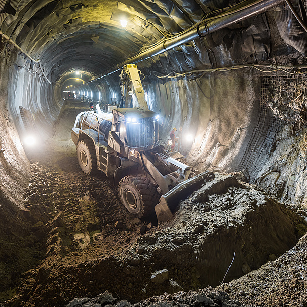 An excavator in a tunnel tube.