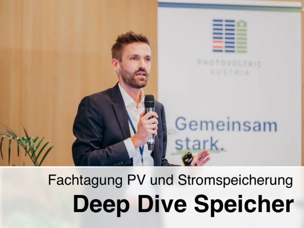 Robert Gaugl in a suit speaks with a microphone at the “PV and Electricity Storage Conference – Deep Dive Storage,” in front of a Photovoltaic Austria banner with the text “Stronger Together.”
