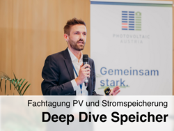 Robert Gaugl in a suit speaks with a microphone at the “PV and Electricity Storage Conference – Deep Dive Storage,” in front of a Photovoltaic Austria banner with the text “Stronger Together.”