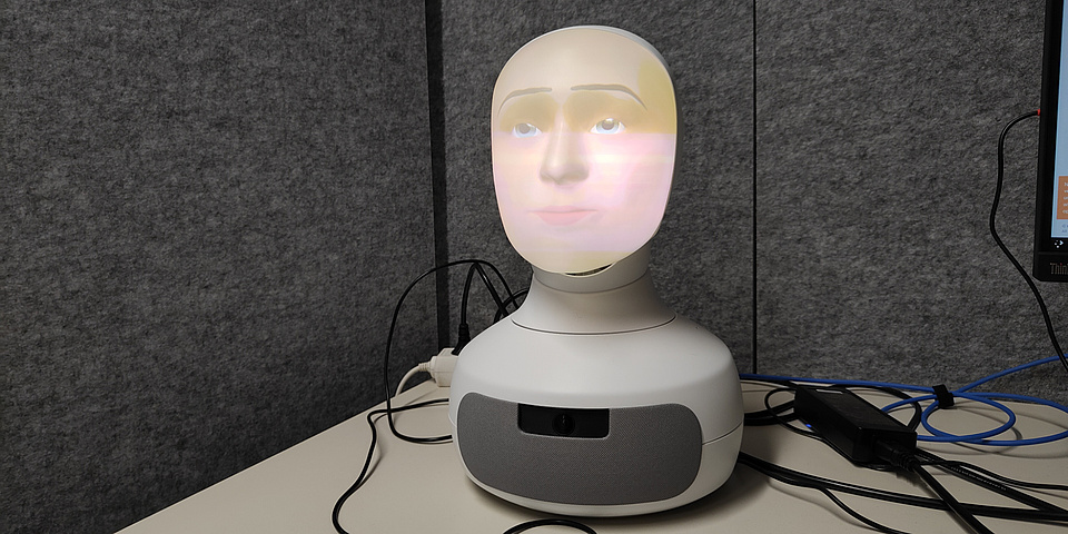 A robot head with a human face