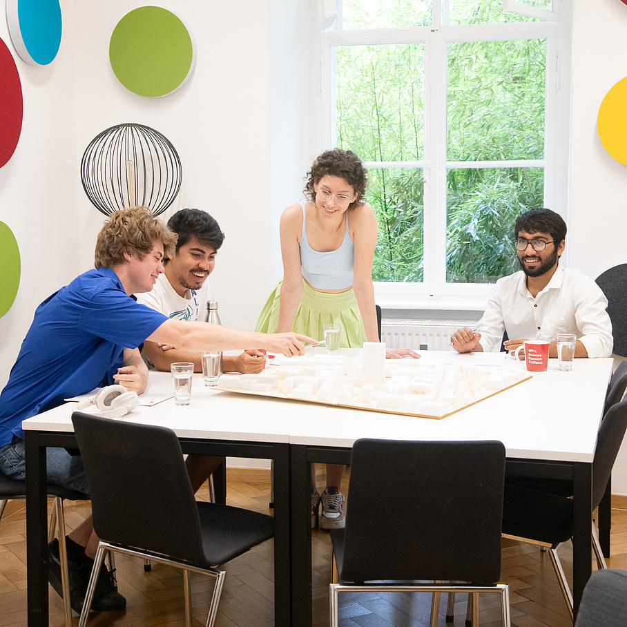 People sit around a table and work together