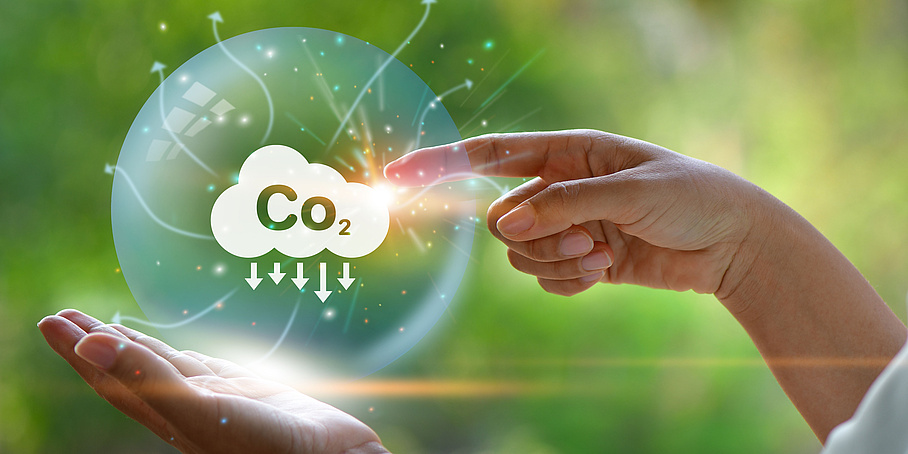 CO2 emission reduction concept in hand with environmental icons
