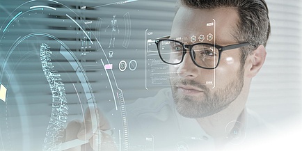 A man stands in front of a data cloud