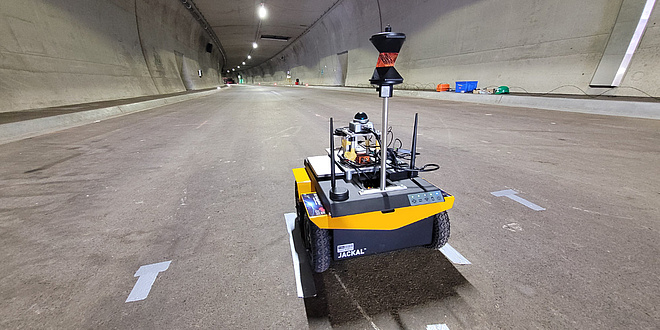 A four-wheeled robot is driving through a tunnel.