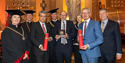 Group of people in festive attire and gown