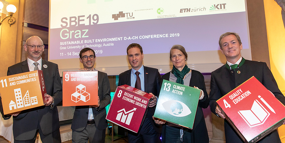 Five people with coloured cardboard cubes in their hands 