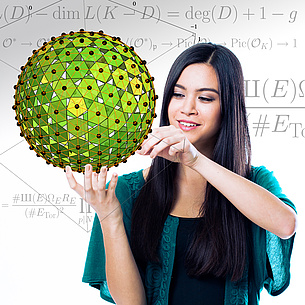 A female student is looking at a polyhedron. In the background you can see mathematical formulas.