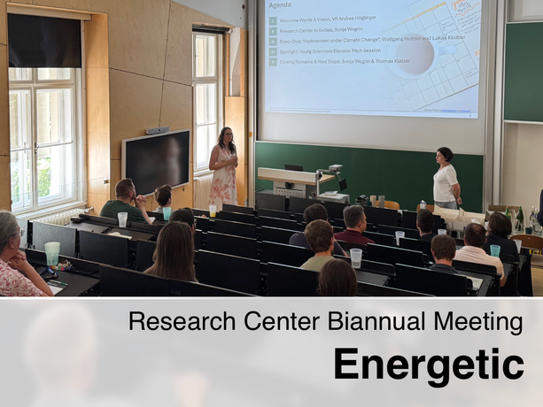 A room full of people listening to a lecture during the Research Center Biannual Meeting "Energetic". Two women are standing at the front of the room, one of whom is giving a presentation. The meeting's agenda is displayed on a screen.