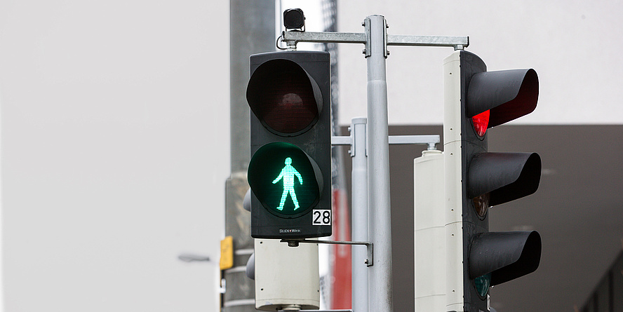 Street situation with pedestrian light on green. 