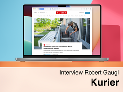 A laptop displaying the "kurier.at" website with an article titled "Save electricity costs and earn money: Why battery storage is booming". The text below the image reads "Interview Robert Gaugl Kurier".