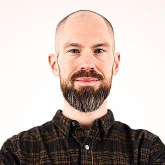 A man smiles into the camera.