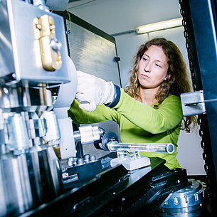 Woman working at a technical device in a laboratory, photo source: Kanizaj - TU Graz