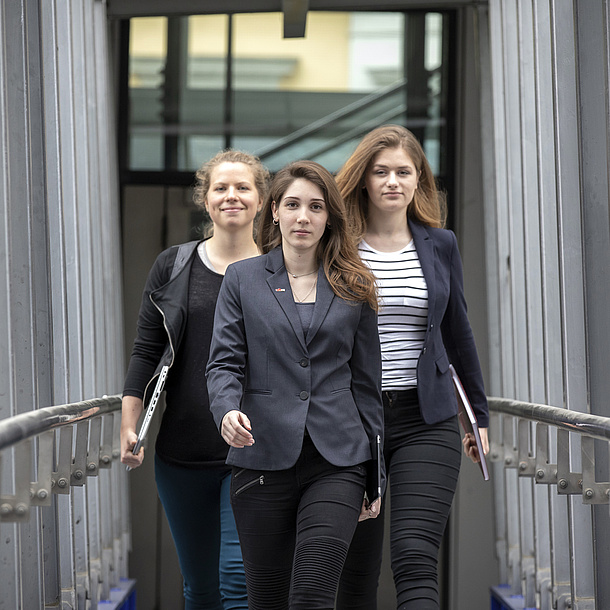 Drei junge Frauen mit entschlossenem Blick.