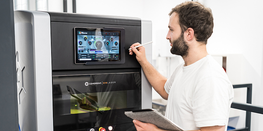 Man in front of 3D printer