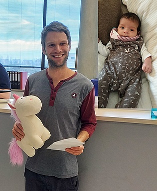 Research Assistant Philipp Bruckner receives a present for his newborn daughter Emilia from the colleagues of the institute. Congratulations and all the best!