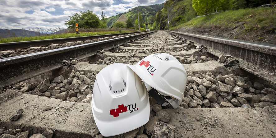 A helmet inbetweet to rail tracks.