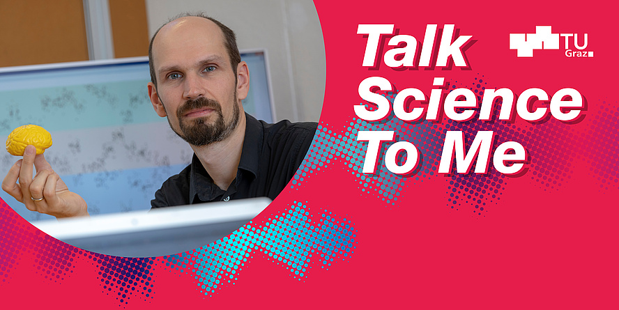 A man holding a yellow brain model. 