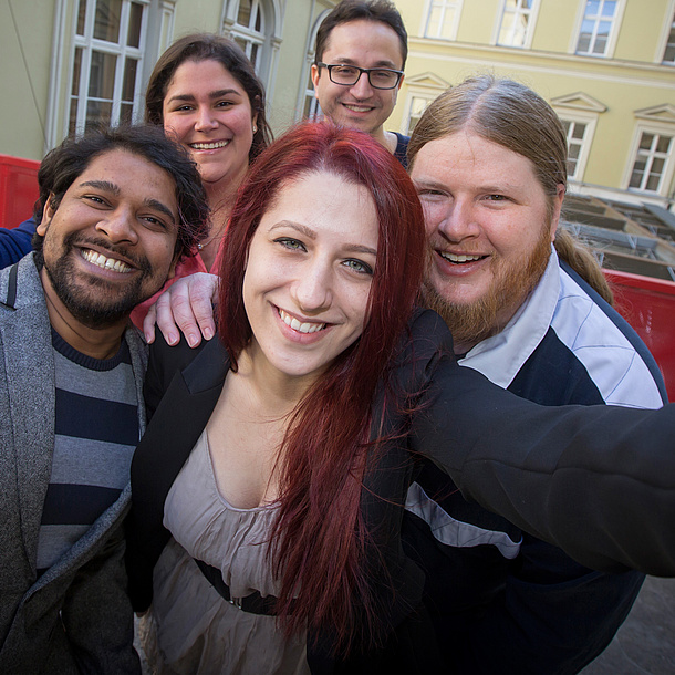 Several people smiling at the camera. Photo source: Lunghammer - TU Graz