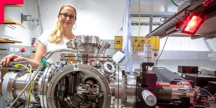 Young woman with glasses in physics lab.