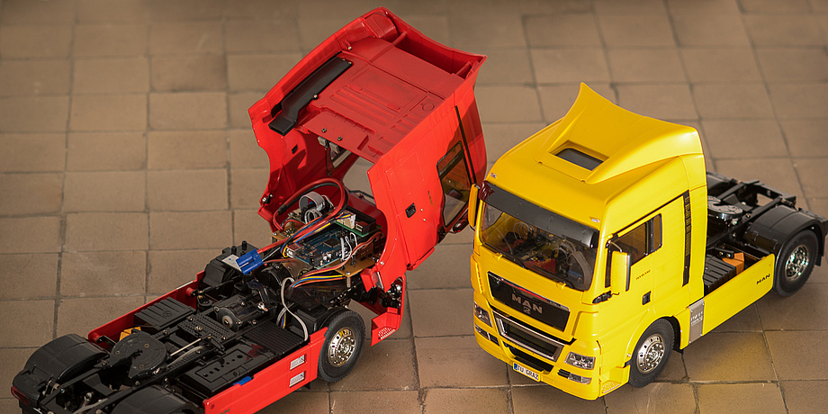 A red and a yellow miniature HGV.