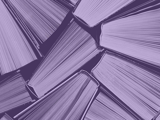 Books with a purple colour filter placed over them.