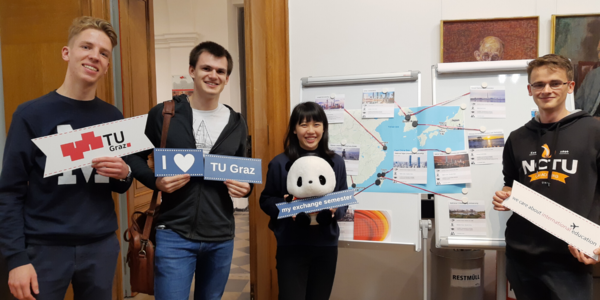 people standing in front of a map and holding signs