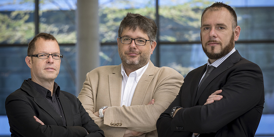 Three men looking at the camera.