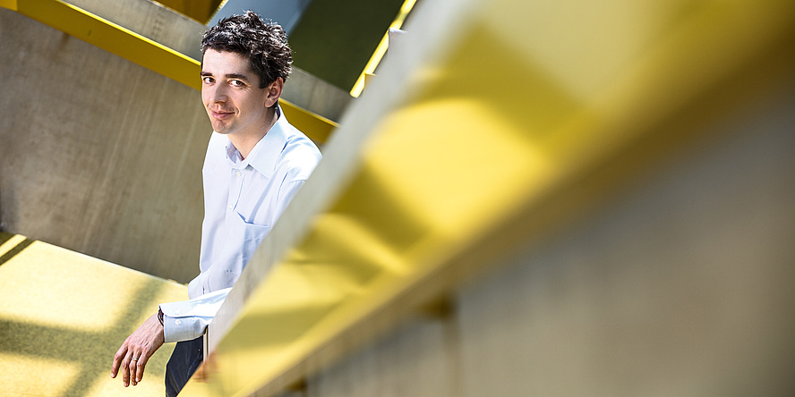 A man is standing on stairs.