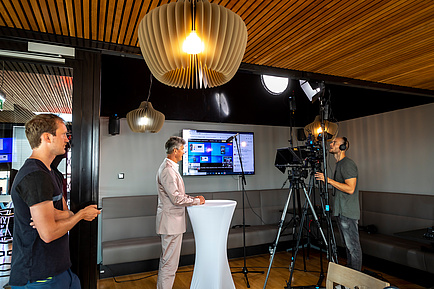 A man is interviewed in front of the camera