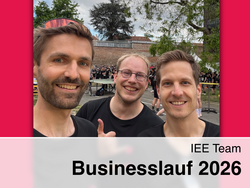 Robert Gaugl, Florian Schimek and Thomas Klatzer in black TU Graz sportswear at Business Run 2026, with crowds, trees, and a brick wall in the background.