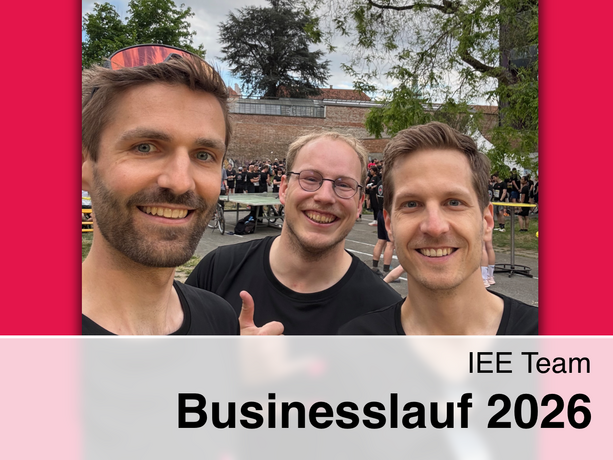 Robert Gaugl, Florian Schimek and Thomas Klatzer in black TU Graz sportswear at Business Run 2026, with crowds, trees, and a brick wall in the background.