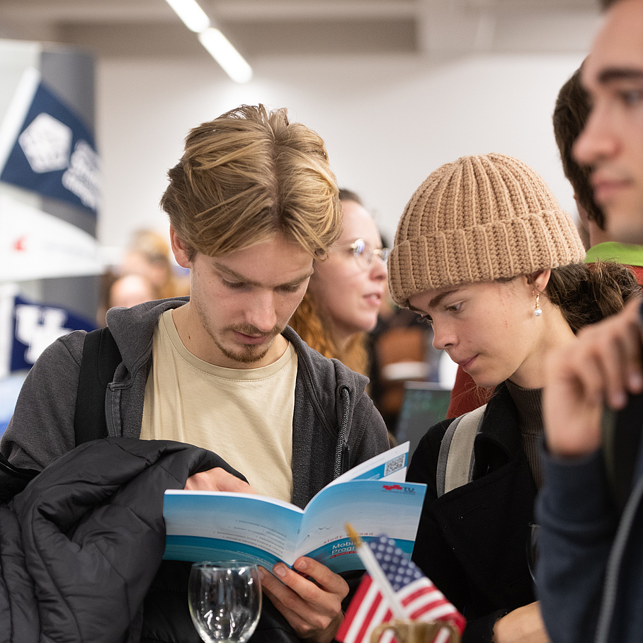 students having a look at the Study Abroad Brochure 
