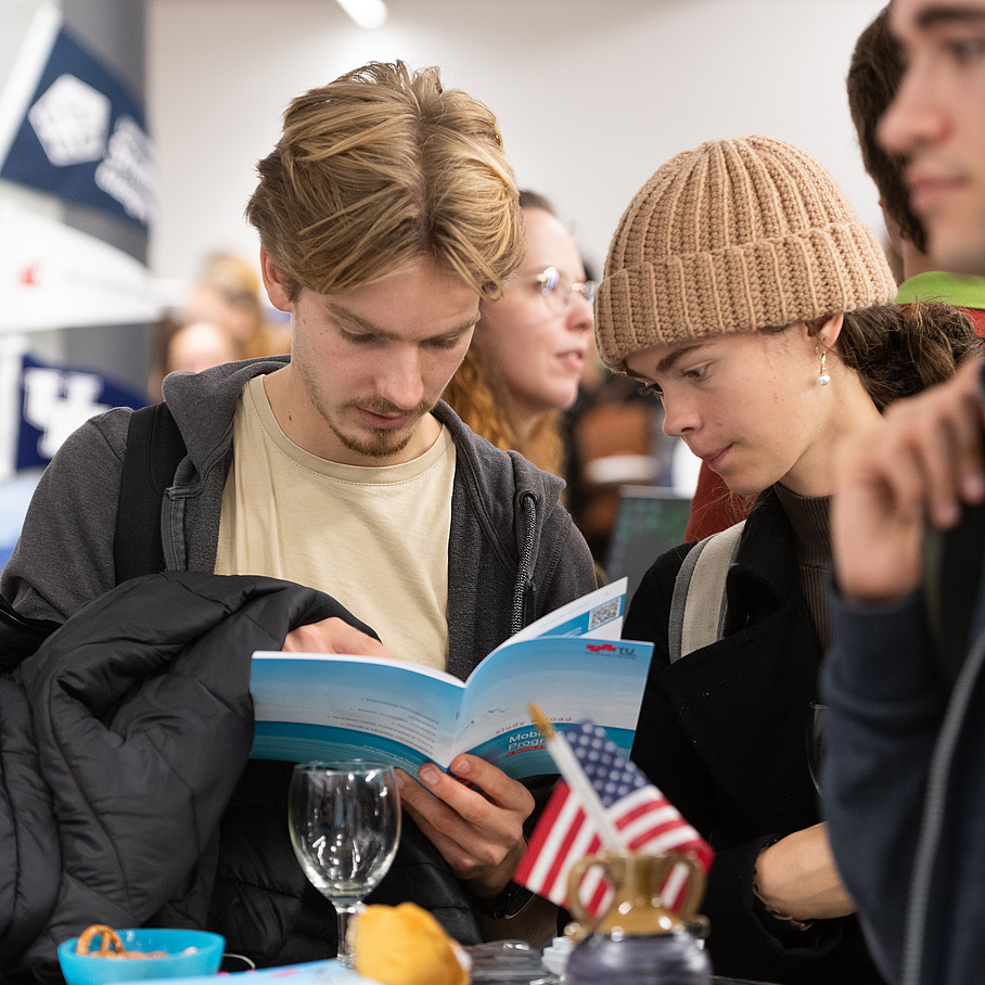 students having a look at the Study Abroad Brochure 