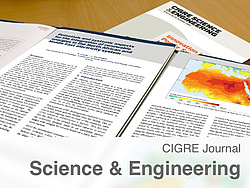 Cigre Journal lies open on the table.