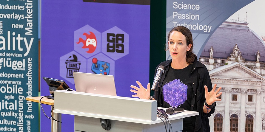 A woman giving a lecture behind a lectern