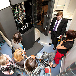 Group of people in front of an electronics cabinet. Photo source: Lunghammer - TU Graz