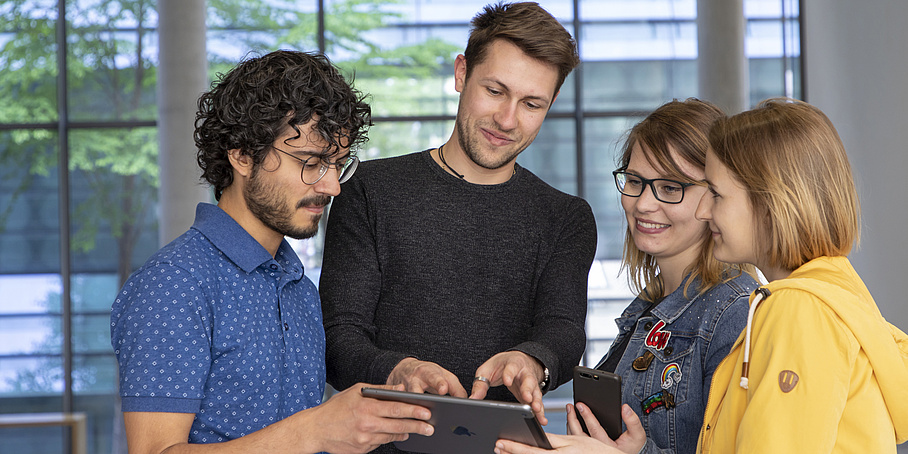 4 people with a tablet.