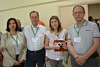 Larisa Karpenko-Jereb and 3 collgeaues of her standing together at the conference.