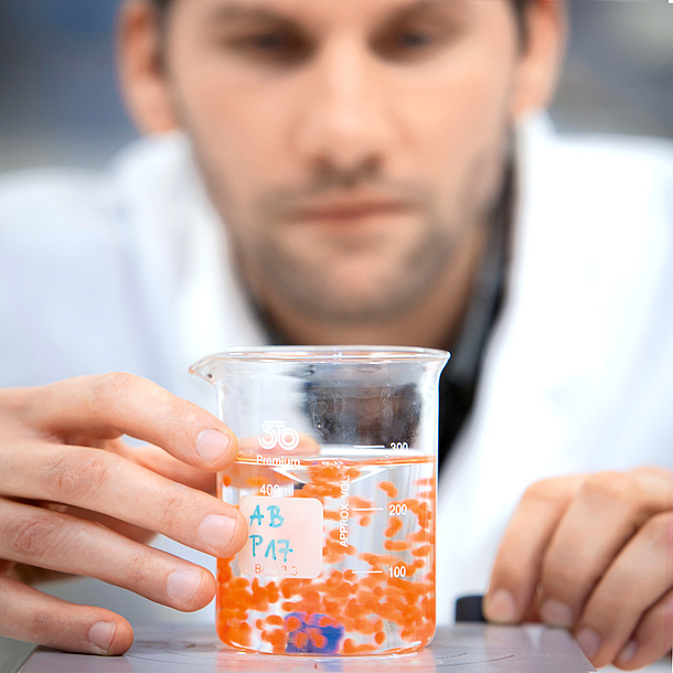 Measuring cup containing an orange liquid floating in a second, almost transparent solution. Photo source: Lunghammer - NAWI Graz