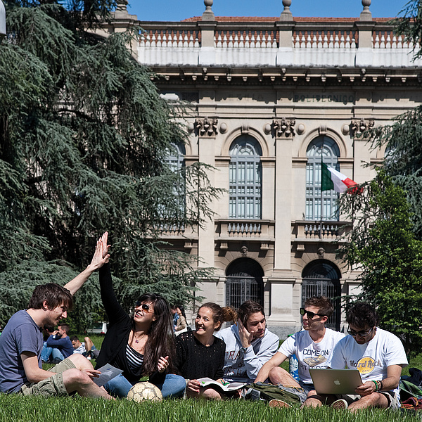 Students sitting in front of the Politecnico di Milano.