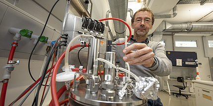 A man handles laboratory equipment